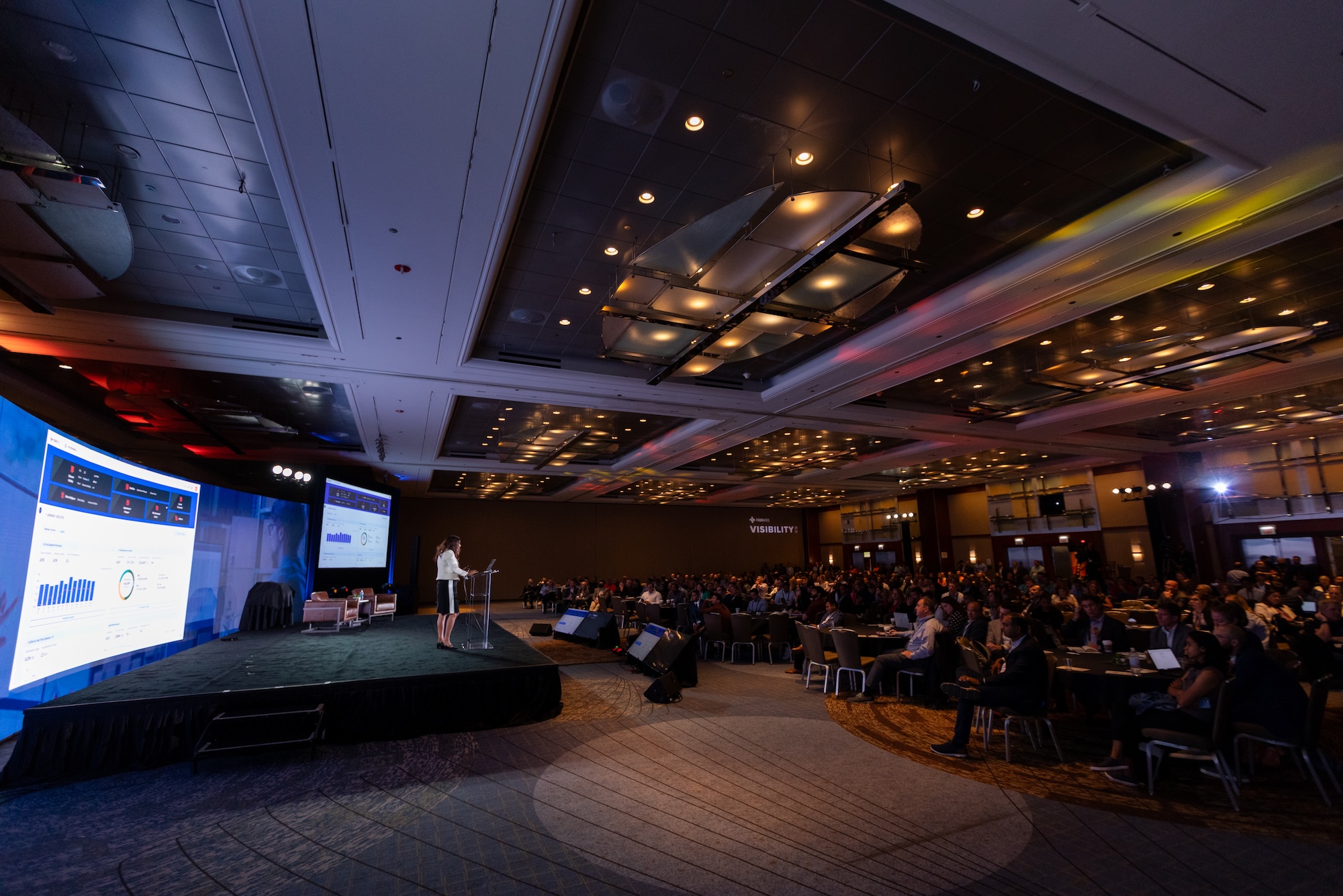 A presenter unveils My Workspace to a large audience at Visibility Conference 2023.